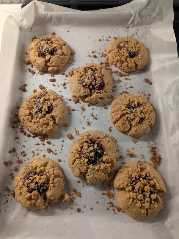 PB&J crumble cookies on parchment paper